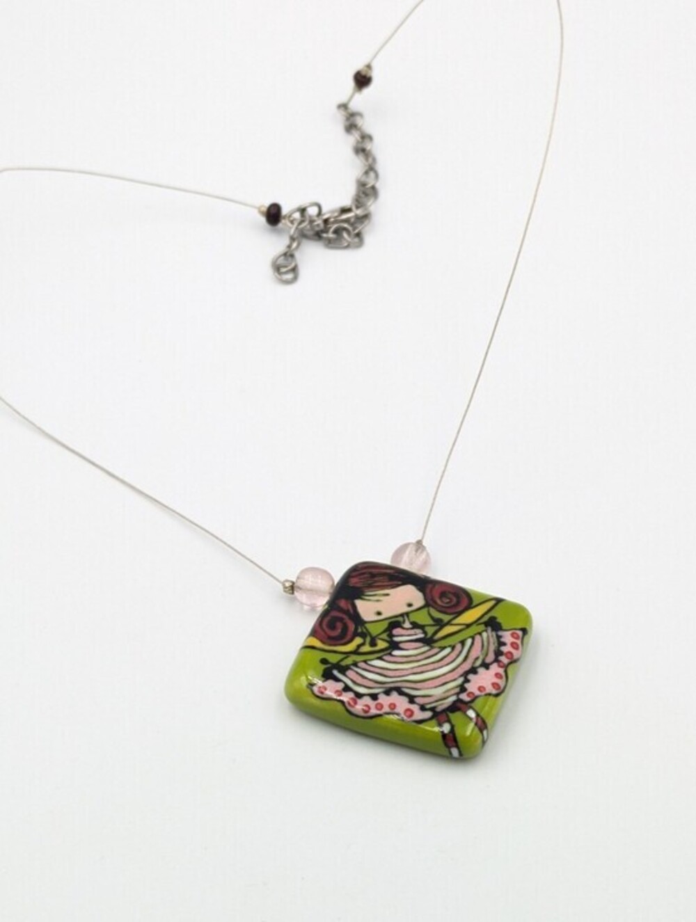 Colourful painted ceramic pendant necklace of girl with dress